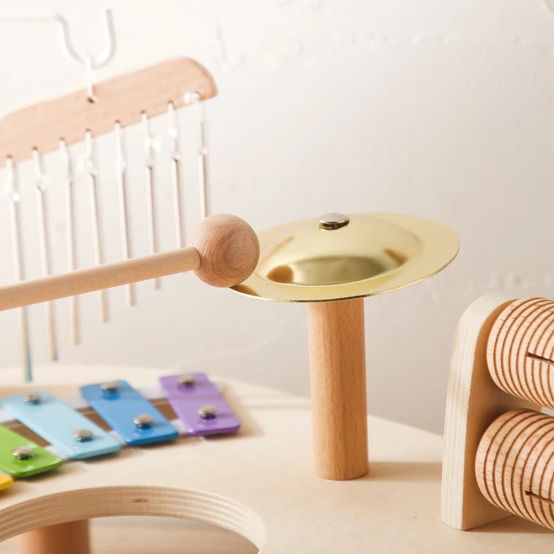 baby playing musical wooden toy supporting infant development